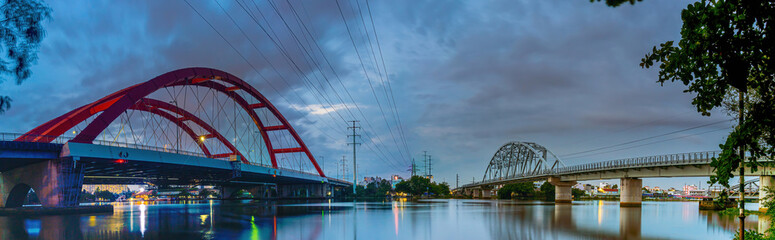 Beautiful sunset on Binh Loi Bridge new and old by night in the rush hour, Ho Chi Minh City, Vietnam.