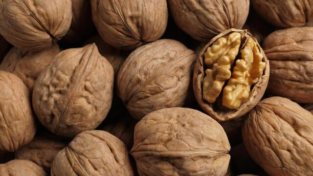 Whole Walnut closeup. Rotating nuts background, nobody