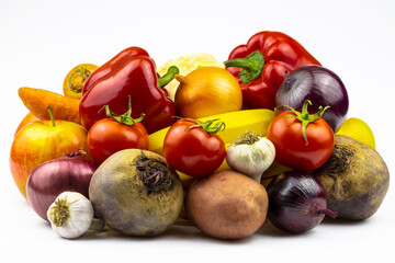 An assortment of vegetables and fruits is isolated on a white background.