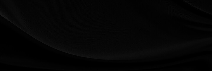 Black gray satin dark fabric texture luxurious shiny that is abstract silk cloth panorama background with patterns soft waves blur beautiful.