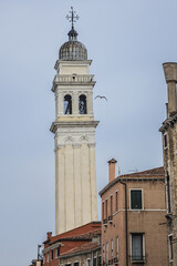 Fototapeta premium View of Rio dei Greci (Greeks' Canal) with the leaning bell tower of the orthodox church of San Giorgio dei Greci (1592) in the background. Venice, Veneto, Italy.