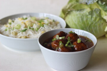 Steamed basmati rice with scrambled eggs and spring onions, called egg rice served along with Vegetable Manchurian