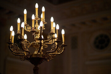 antique bronze candlestick with bulbs and monograms.