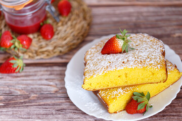 Slice of Shaker Lemon Pie onwhite plate with strawberries. Lemon tart.
