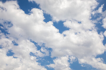 White cumulus clouds on blue sky