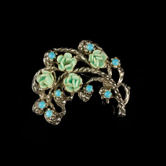 Round antique brooch with precious stones and crystals in the shape of a flower. Vintage brooch in...