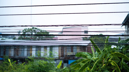 Fototapeta na wymiar The rain that falls on the wires in the rainy season Thailand