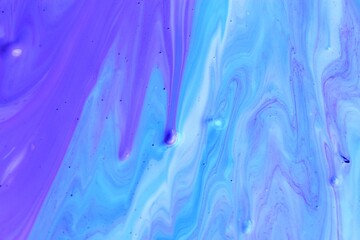 Abstract purple-blue marble background. The effect of natural stone. Acrylic paint flows freely and...