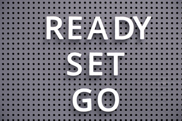 Words Ready, Set, Go spelled out with white letters on gray pegboard