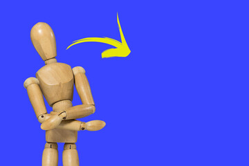 Wooden figure doll pose in cross arms gesture on colorful background and yellow arrow with space to write