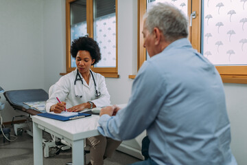 Female doctor examining a senior patient