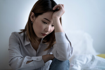 Asian woman is introverted alone in her bedroom, She is lonely and has stress, Depression.