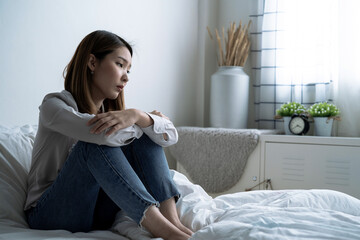 Asian woman is introverted alone in her bedroom, She is lonely and has stress, Depression.