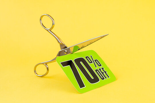Scissors cutting the price tag