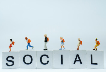 Miniature people : Group of student are walking on the wording social use as networking , education and learning development concept