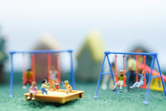 Miniature people : Children are enjoy playing together at the playground with many plaything use as children day concept.
