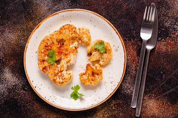 Cauliflower steak with spices cooked in the oven, top view.