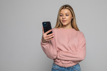 Portrait of pretty woman in shirt, denim outfit holding hand in pocket of jeans, having smart...