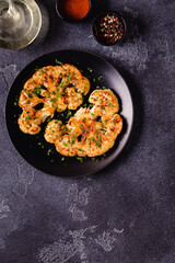 Cauliflower steak with spices cooked in the oven, top view.