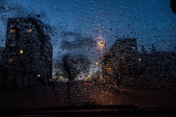 View from the car window through the rain in the evening. Background.