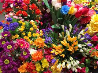 Fototapeta premium Artificial flowers counter is an alternative to live flowers. Flowers from paper and fabric. Artificial flowers are created as realistic as possible. Decor for weddings and funerals.
