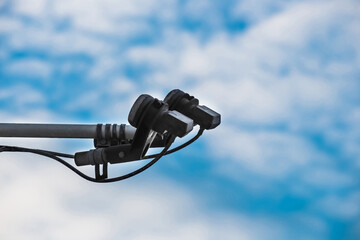 Feedhorn of a satellite dish against a blue sky, close-up