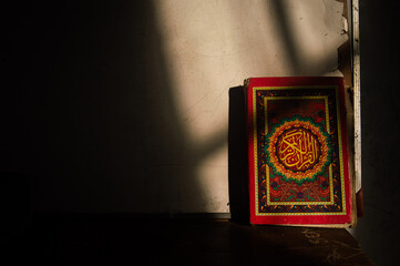 Al-Quran on the wall in the shadow