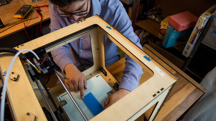 man working on a 3d printing in his workshop