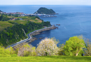 Fototapeta na wymiar Road on the coast of Gipuzkoa and the tourist town of Getaria next to the Cantabrian Sea, Euskadi