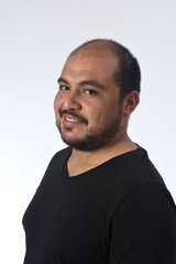 Fototapeta premium portrait of a latin man smiling and looking at camera on white background