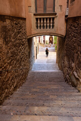 Arch in the street of Pujada de Sant Domenech, Agullana Palace in the background olt town of...