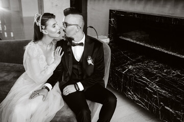 Fototapeta na wymiar Stylish wedding couple in the interior. Glamorous bride and groom, black and white photo