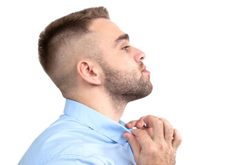 Fototapeta premium Portrait of a young man in a blue shirt on a white background
