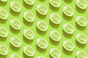 Pattern with halves of lemon with shadow on green background