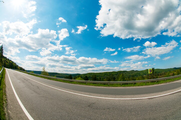 highways in the mountains against the background of the sunny sky and the white clouds