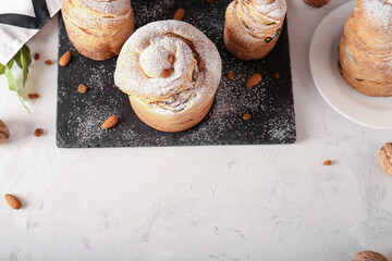 Closeup of homemade easter kraffins with raisins and icing sugar on a cutting board. Homemade holiday cakes kulich kraffin.