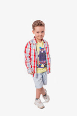 Funny cute little adorable caucasian boy posing in studio on white background