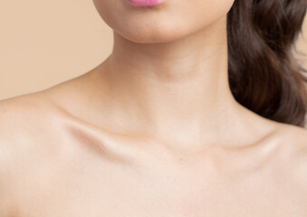 Women neck and shoulders on nude background