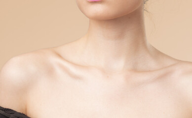 Women neck and shoulders on nude background - obrazy, fototapety, plakaty