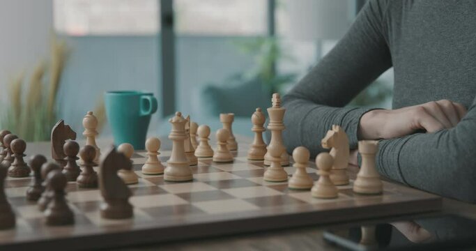 Woman moving the king on the chessboard