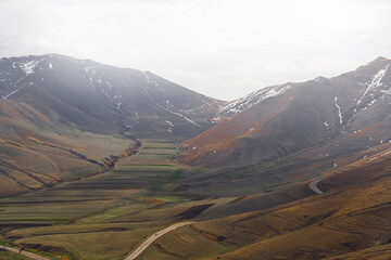 Panoramic view of the mountains in the fog, spring moody landscape.