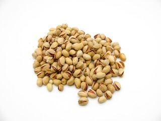 A pile of fried pistachios on a white background