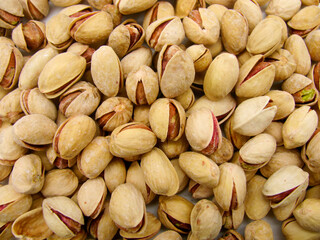 A pile of fried pistachios nearby. Background.