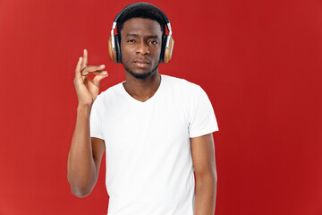 man of african appearance in headphones shows finger technology