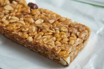 Granola bar with nuts and seeds on open package