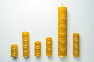 Decorative candles made of beeswax with a honey aroma for interior and tradition on the white background.
