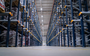 Horizontal camera move between the rows shelves with cardboard boxes and plastic packs on a palette. Logistics center interior full of racks with with large number packs.