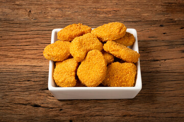 Fried chicken nuggets with ketchp and rose sauce.