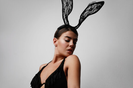 Portrait of young woman with bunny ears looking aside.