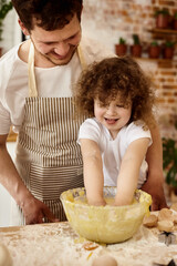 daughter helps dad in the kitchen